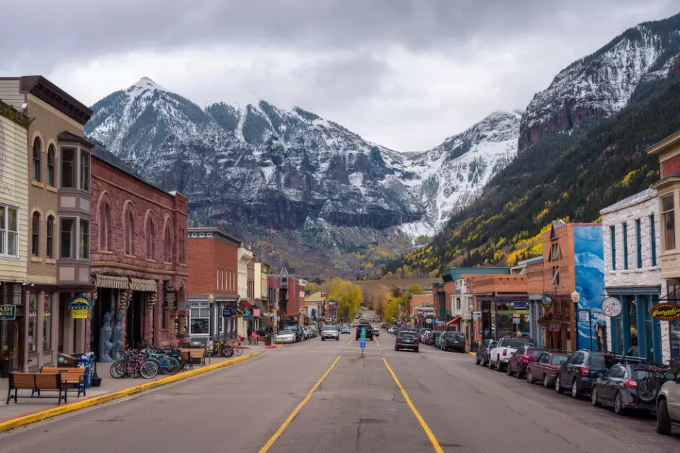 View from middle of street in downtown Telluride, Colorado with mountains in background